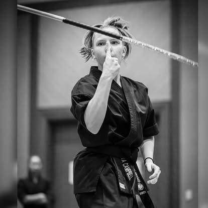 Adult martial artist demonstrating a weapons form