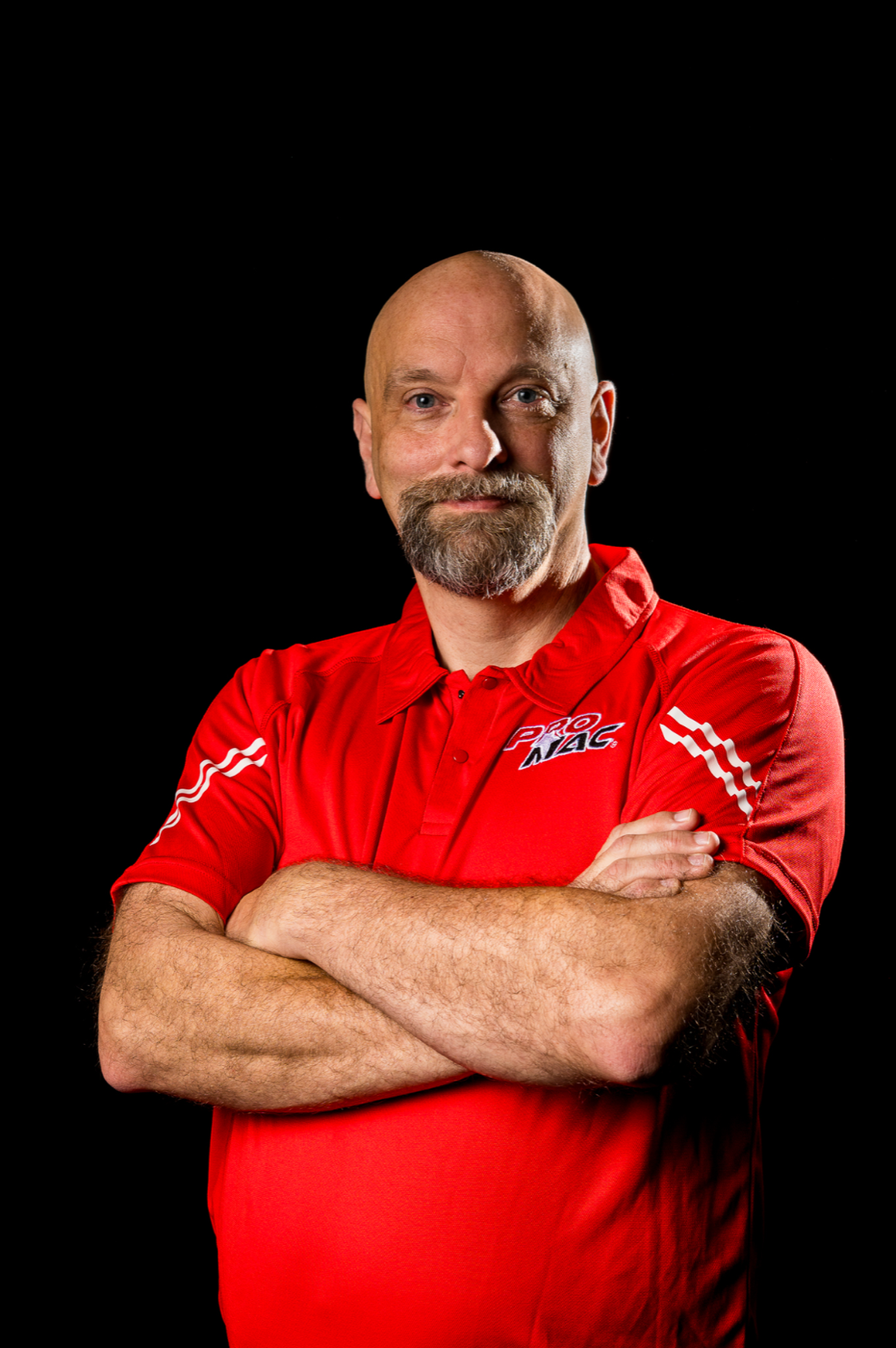 PROMAC official in red polo standing for a professional portrait