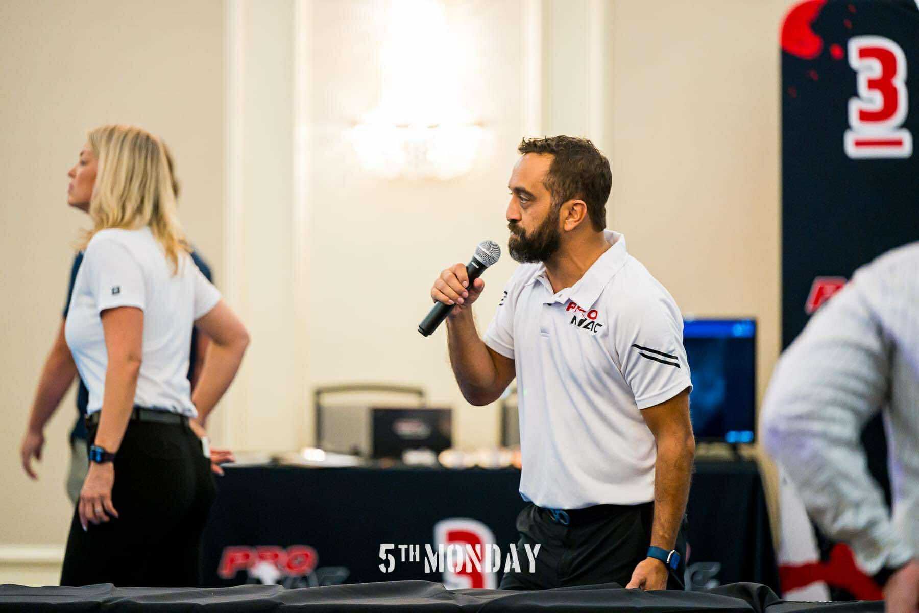 PROMAC ring director speaking during a professional martial arts event